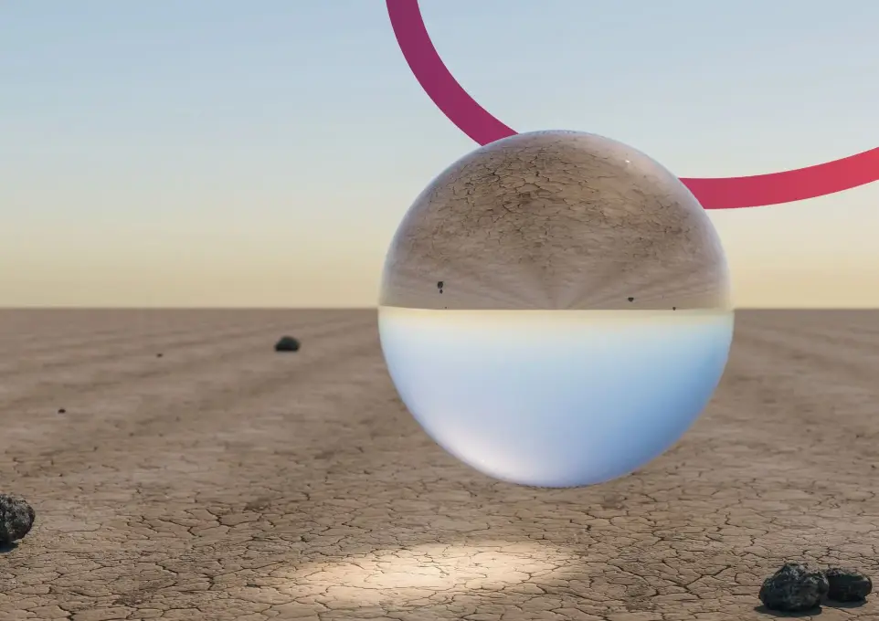 Sfondo desertico e cielo azzurro con una sfera trasparente che riflette in modo speculare lo sfondo. Piccolo arco rosso dietro la sfera